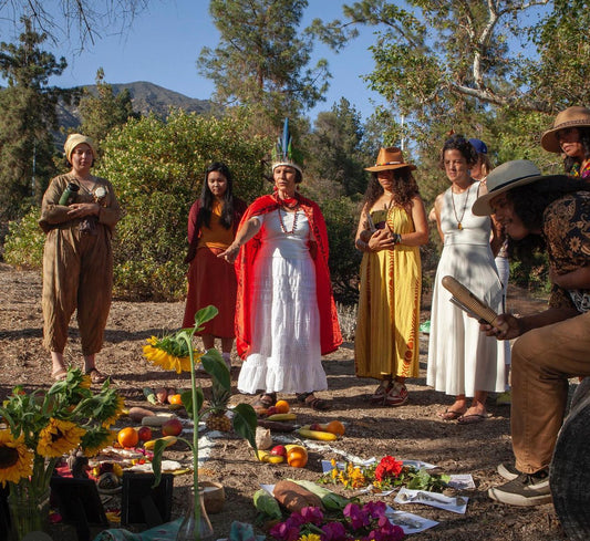 Akutu Irka surrounded by community standing in front of a Taino altar in celebration and honor of the Summer Solstice.