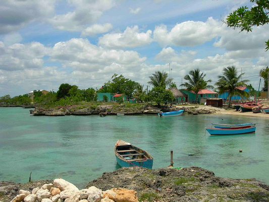 boats in crystal blue water in the Bayahibe village